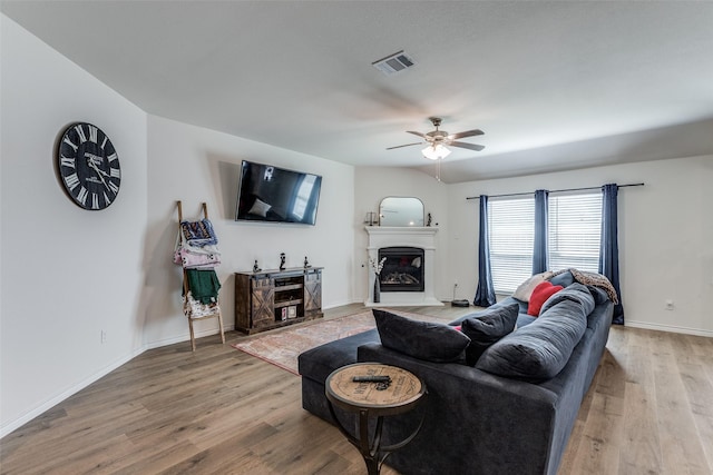 living room with ceiling fan and light hardwood / wood-style floors