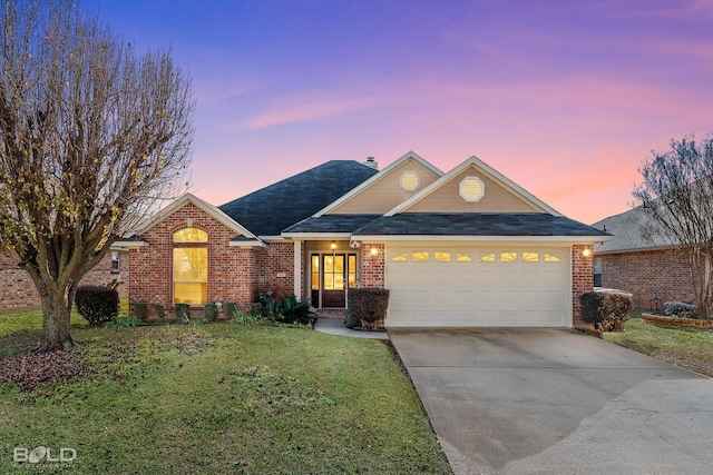 view of front of home featuring a yard and a garage