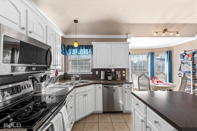 kitchen featuring white cabinets, sink, appliances with stainless steel finishes, and tasteful backsplash