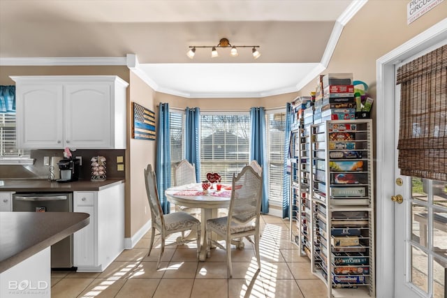 dining space with light tile patterned flooring and ornamental molding