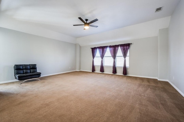 carpeted spare room featuring lofted ceiling and ceiling fan