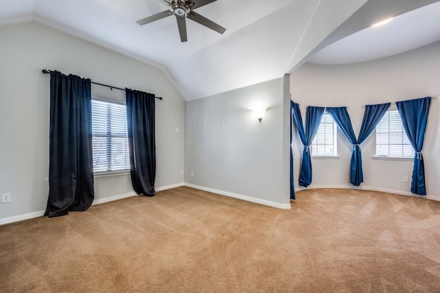 unfurnished room featuring lofted ceiling, carpet, a ceiling fan, and baseboards