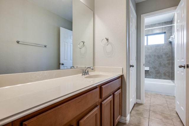 bathroom featuring tiled shower / bath, vanity, and tile patterned floors