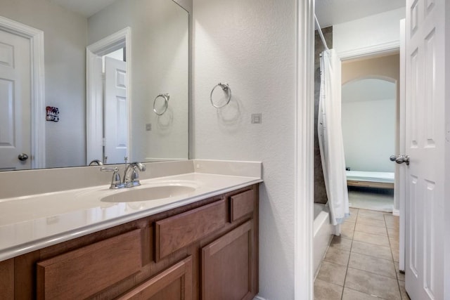 bathroom featuring tile patterned flooring, vanity, and shower / tub combo