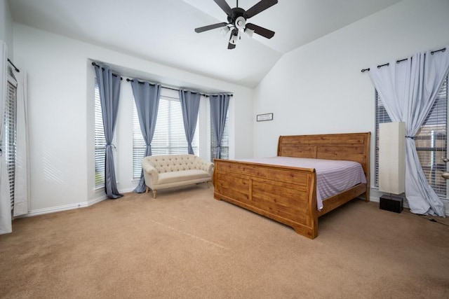 bedroom with light carpet, baseboards, vaulted ceiling, and a ceiling fan