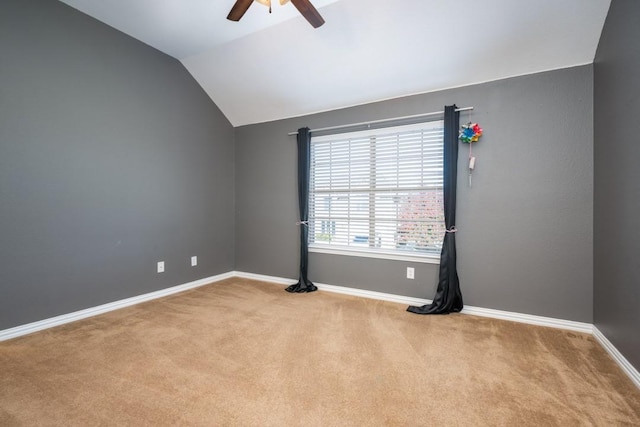 unfurnished room featuring carpet floors, lofted ceiling, baseboards, and a ceiling fan