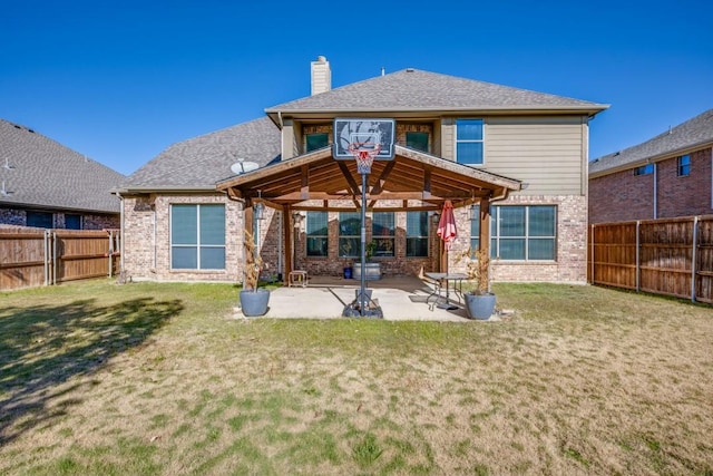 rear view of property featuring a yard and a patio area