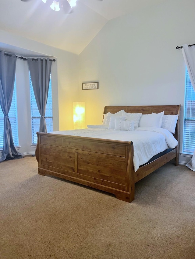 bedroom featuring light colored carpet, ceiling fan, and vaulted ceiling