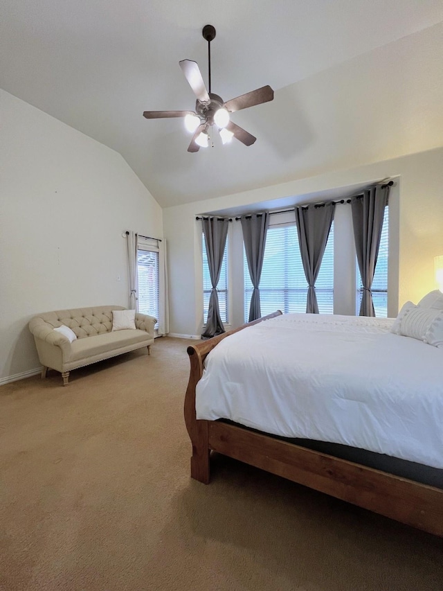 carpeted bedroom with ceiling fan and vaulted ceiling