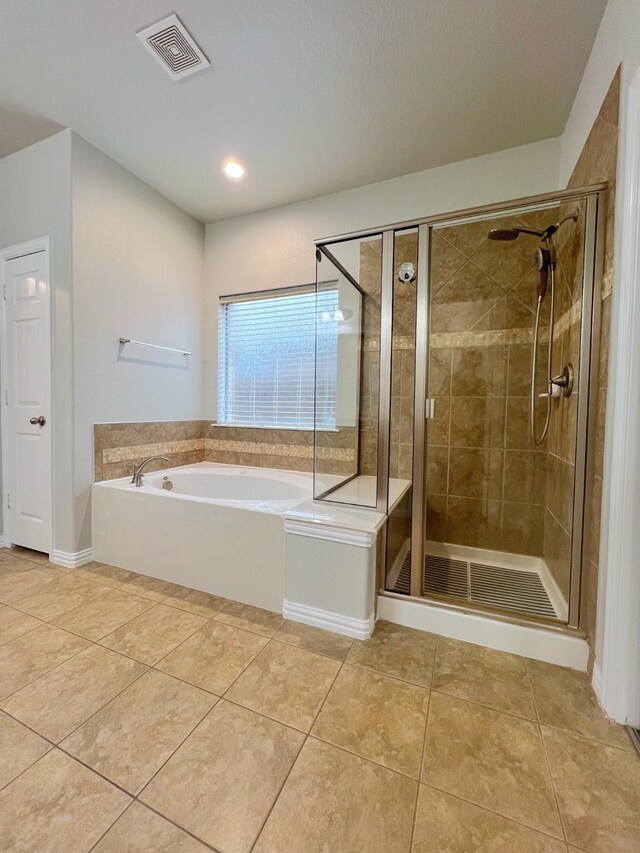 bathroom with a garden tub, tile patterned flooring, a shower stall, and visible vents