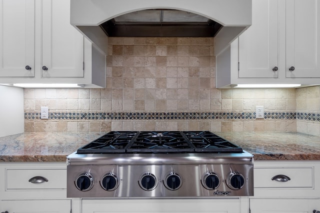 kitchen featuring decorative backsplash, white cabinets, light stone countertops, and stainless steel gas cooktop