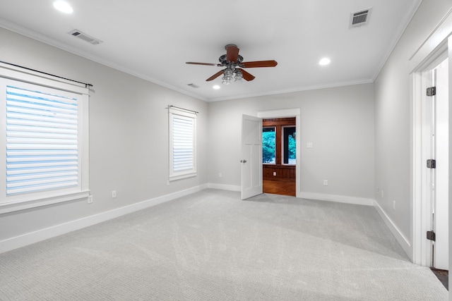 unfurnished bedroom with ceiling fan, light colored carpet, and ornamental molding