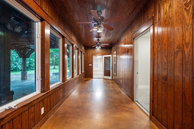 hallway featuring wooden walls and wood ceiling