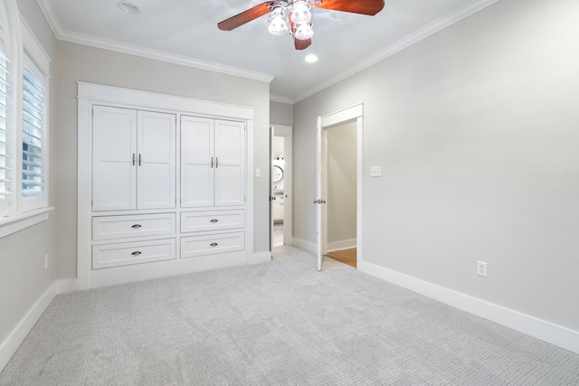 unfurnished bedroom featuring ceiling fan, crown molding, and light carpet