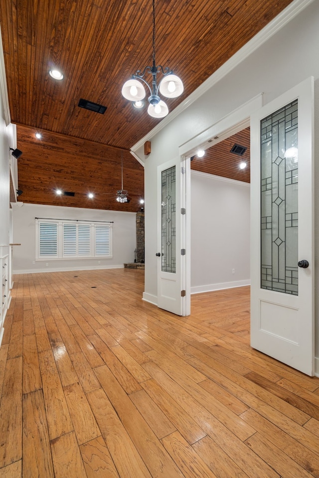 interior space with crown molding, a chandelier, light hardwood / wood-style flooring, and wood ceiling