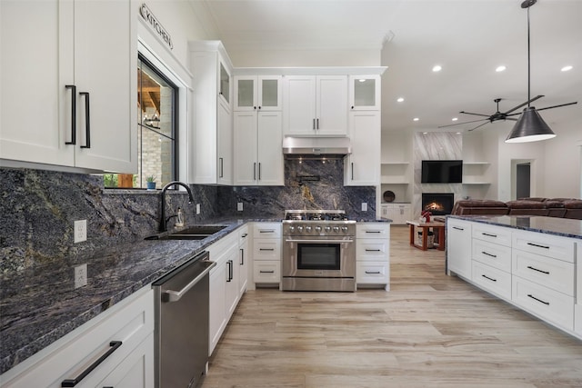 kitchen featuring white cabinets, sink, hanging light fixtures, ceiling fan, and stainless steel appliances