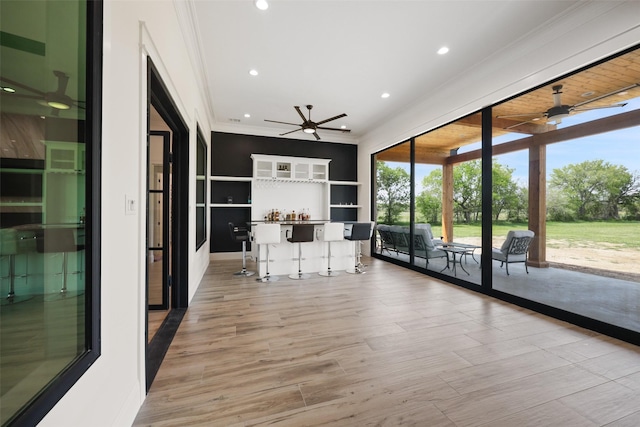 interior space featuring ceiling fan and ornamental molding