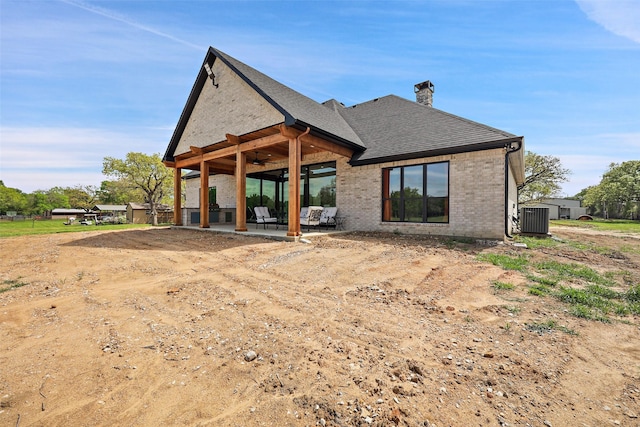 back of house featuring central AC unit, ceiling fan, and a patio area