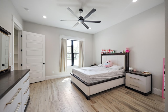 bedroom with ceiling fan and light hardwood / wood-style flooring