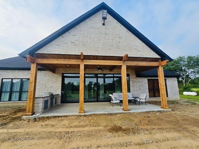 back of house with a patio area, ceiling fan, and an outdoor kitchen