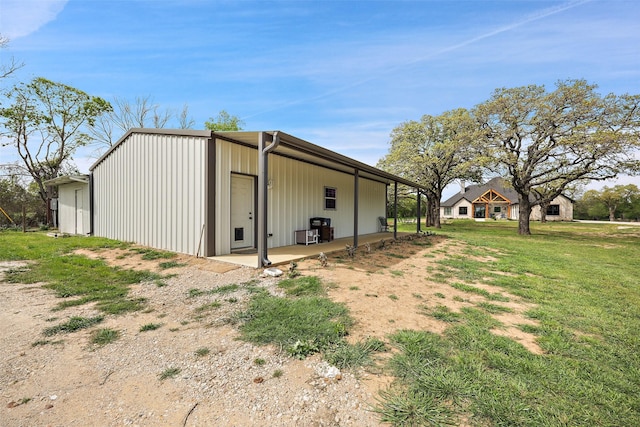 view of outbuilding featuring a yard