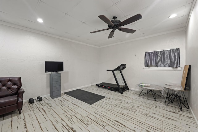 exercise room featuring ceiling fan and ornamental molding