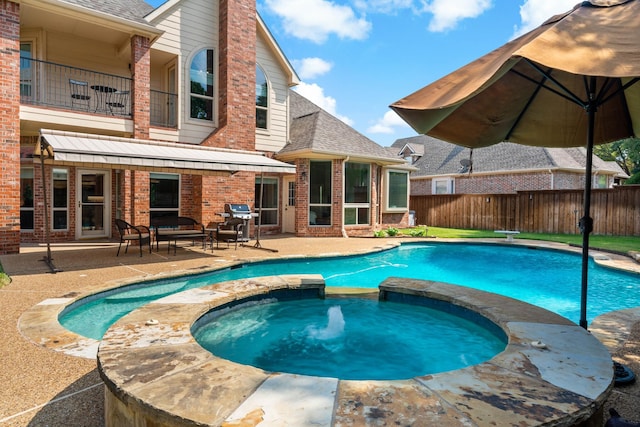 view of swimming pool featuring grilling area, an in ground hot tub, and a patio