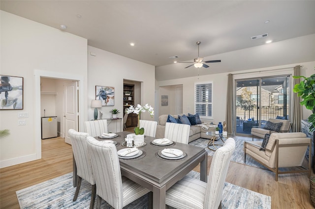 dining room with lofted ceiling, light hardwood / wood-style flooring, and ceiling fan