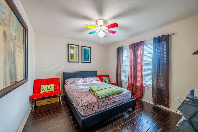 bedroom with ceiling fan and dark hardwood / wood-style floors