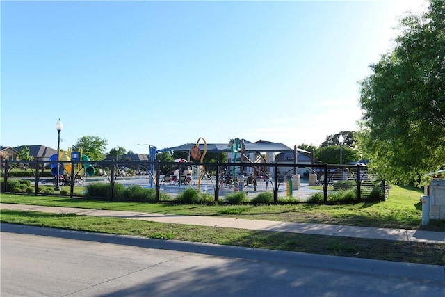 surrounding community featuring a playground and a lawn