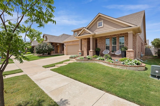 craftsman house featuring a front yard, covered porch, and a garage