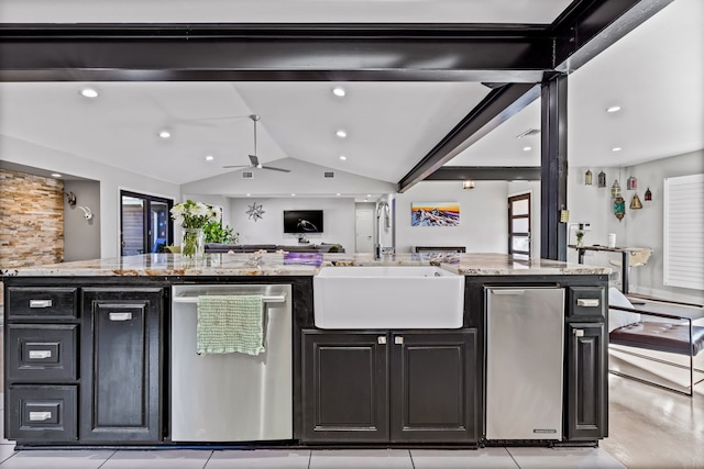 kitchen with dishwasher, lofted ceiling, sink, light stone countertops, and an island with sink