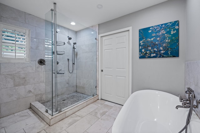 bathroom with separate shower and tub