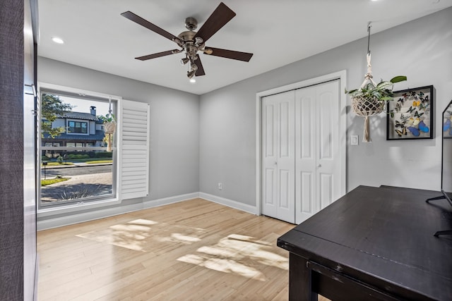 office featuring ceiling fan, light hardwood / wood-style flooring, and a healthy amount of sunlight