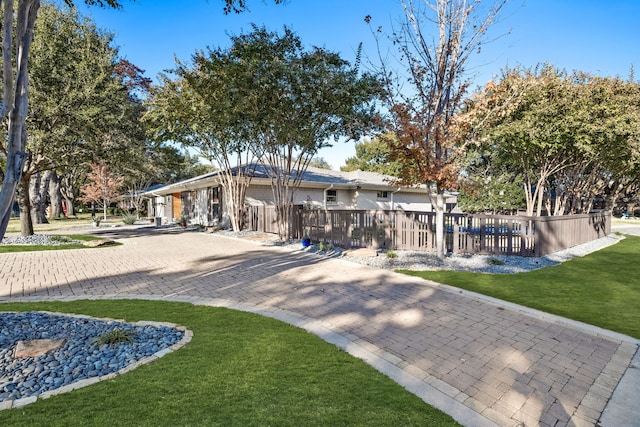 rear view of house featuring a lawn