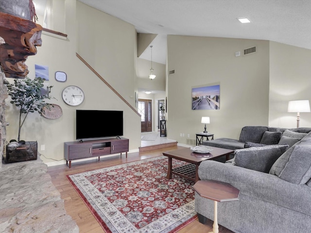 living room featuring lofted ceiling and hardwood / wood-style floors