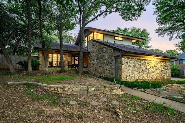 view of back house at dusk