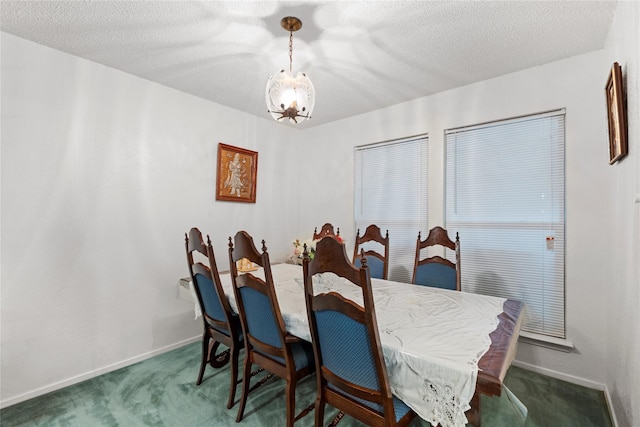 dining room with dark colored carpet and a textured ceiling