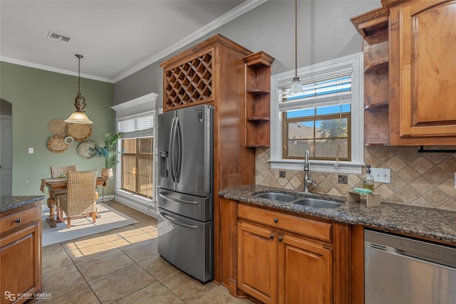 kitchen featuring appliances with stainless steel finishes, crown molding, sink, light tile patterned floors, and pendant lighting