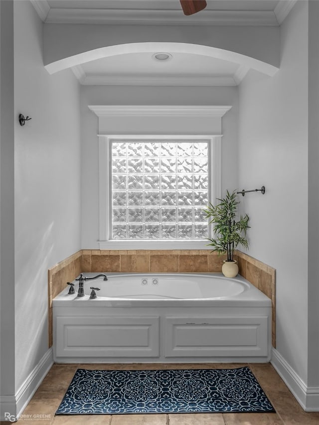 bathroom with tile patterned floors, a bathtub, and ornamental molding