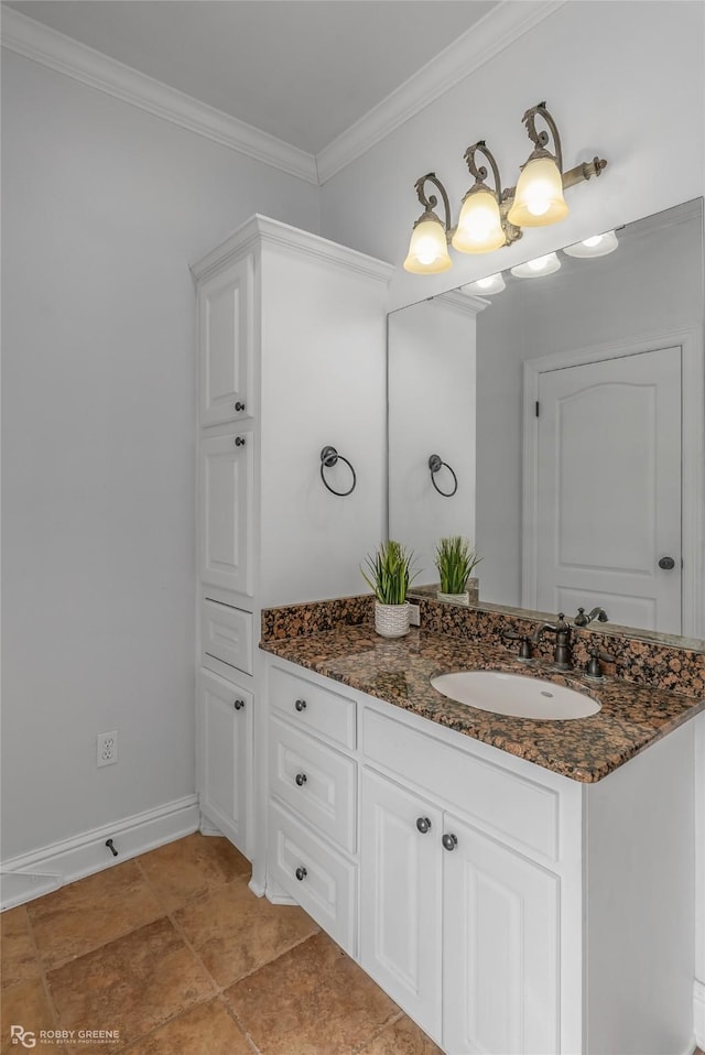 bathroom with crown molding and vanity