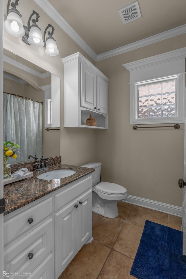 bathroom with vanity, toilet, plenty of natural light, and ornamental molding