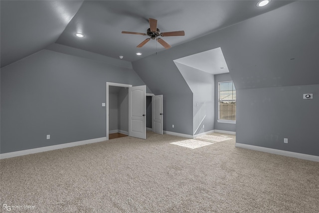 bonus room featuring ceiling fan, light colored carpet, and vaulted ceiling