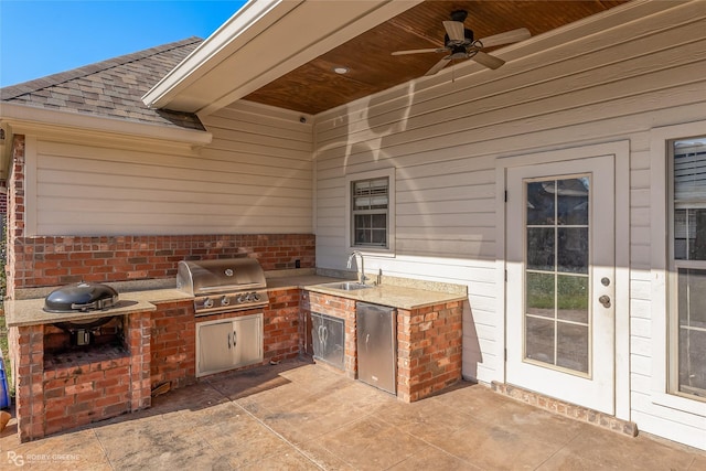 view of patio with area for grilling, ceiling fan, and sink