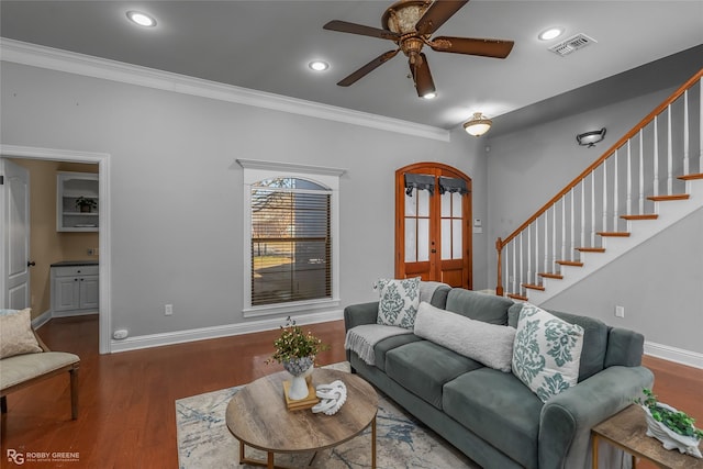 living room featuring ceiling fan, crown molding, and dark wood-type flooring