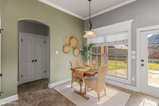 tiled dining room featuring ornamental molding