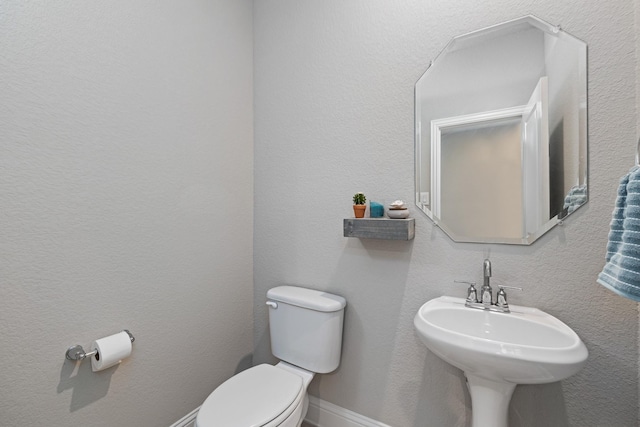 bathroom featuring toilet and sink