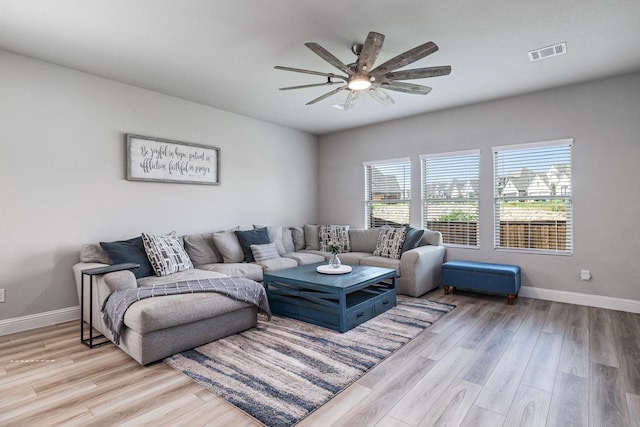 living room featuring light wood-type flooring and ceiling fan