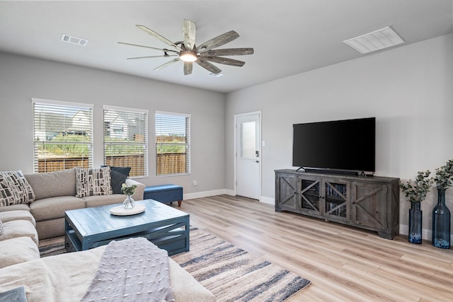 living room with ceiling fan and light hardwood / wood-style flooring