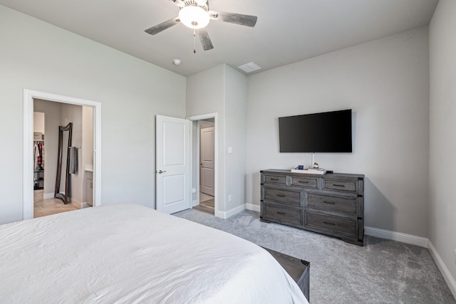 carpeted bedroom with connected bathroom and ceiling fan